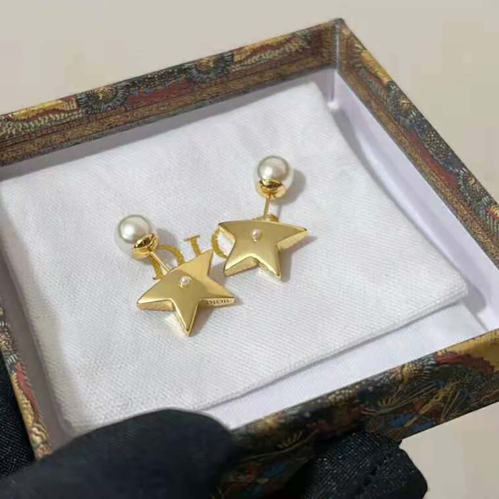 Detail of white resin pearl on Dior Women Tribales Earrings gold metal