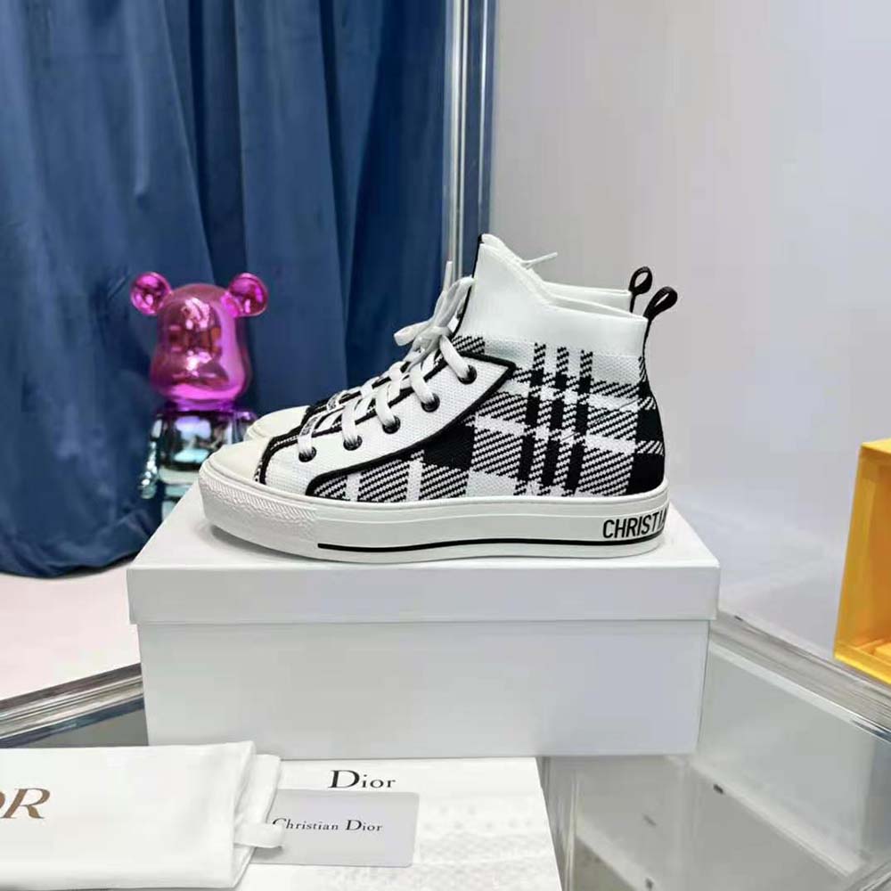 Top angle showing white laces and Dior branding on sneaker tongue