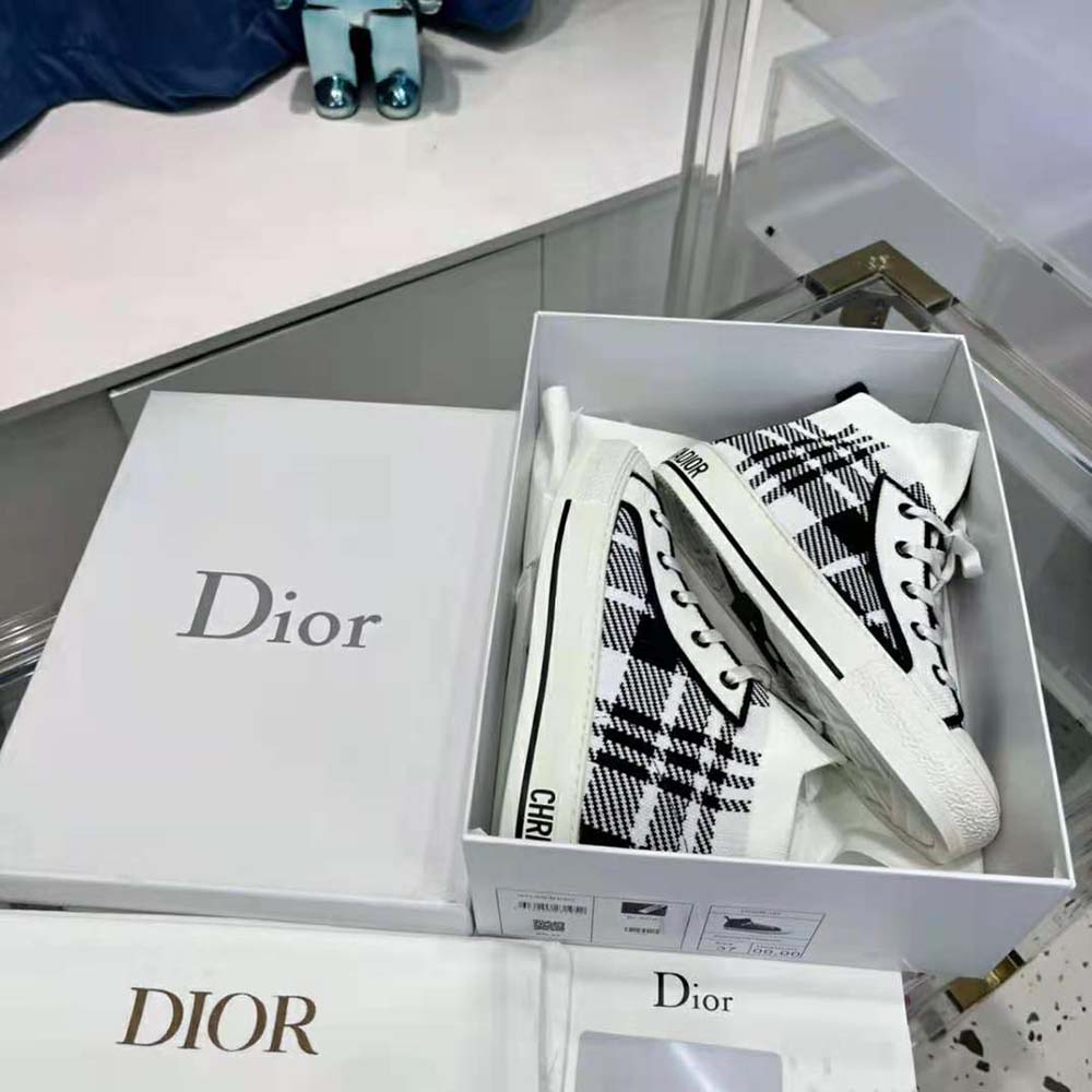 Close-up of signature check’n’Dior print on sneaker upper
