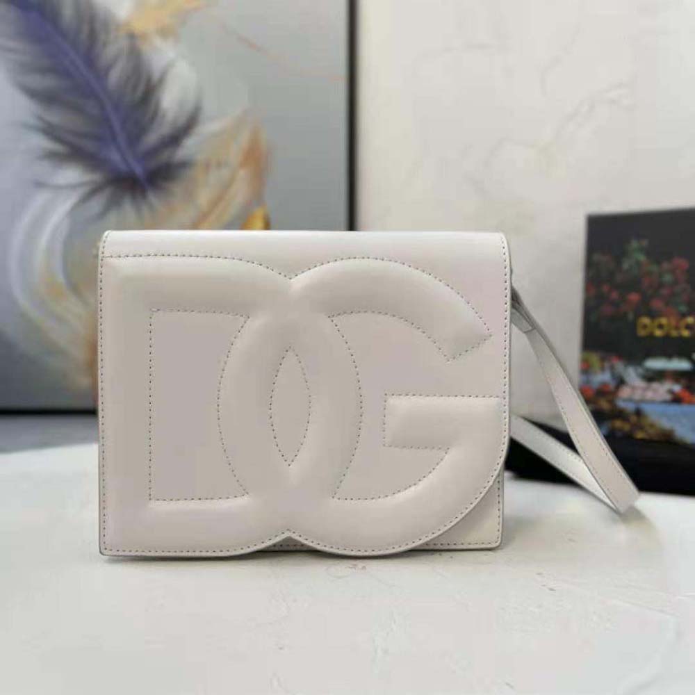 Close-up of gold DG logo hardware on white calfskin bag