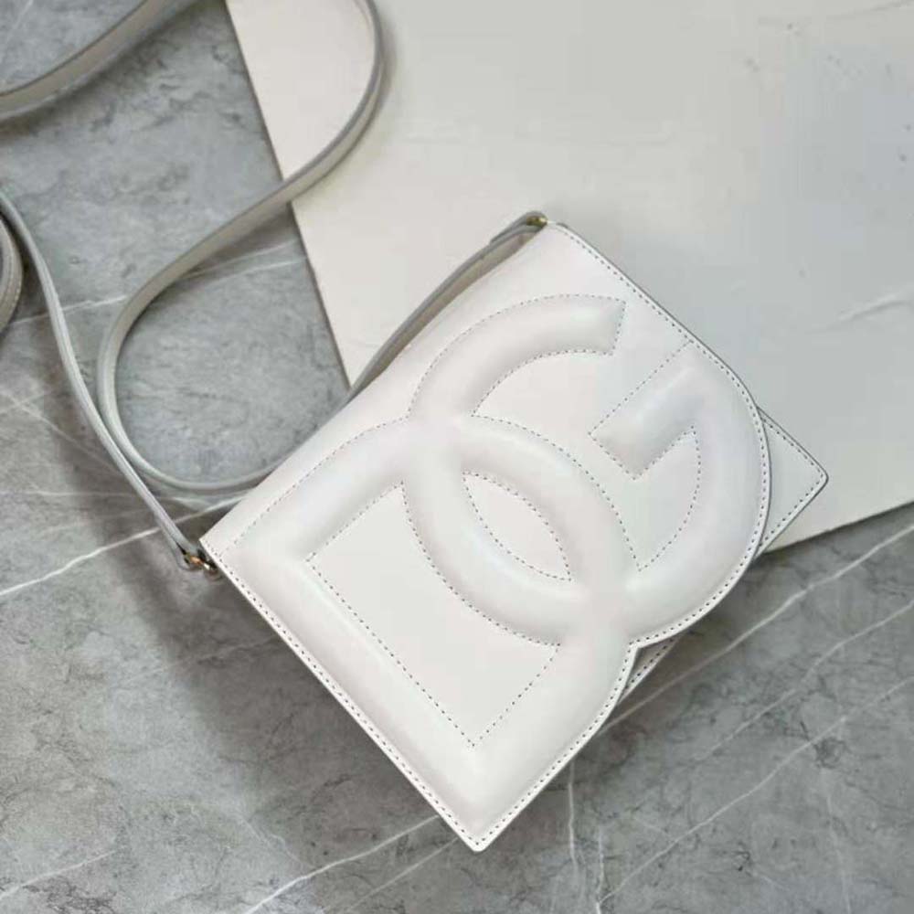 Side profile showing adjustable strap on Dolce Gabbana white crossbody bag
