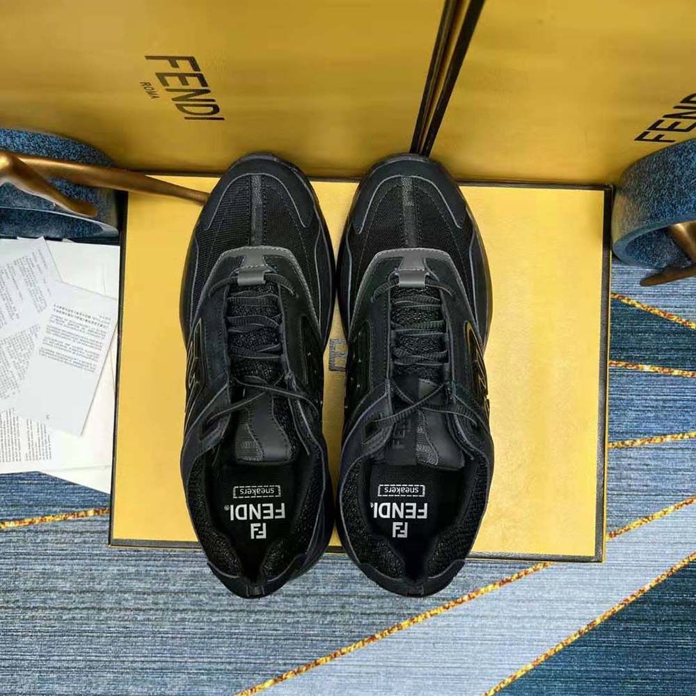 Close-up on Fendi signature hardware on black nubuck leather trainers