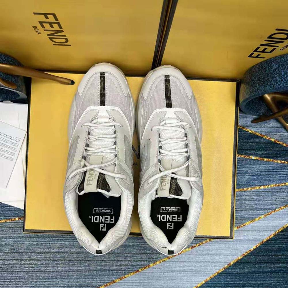 Close-up of Fendi logo embossed on heel of white nubuck trainers