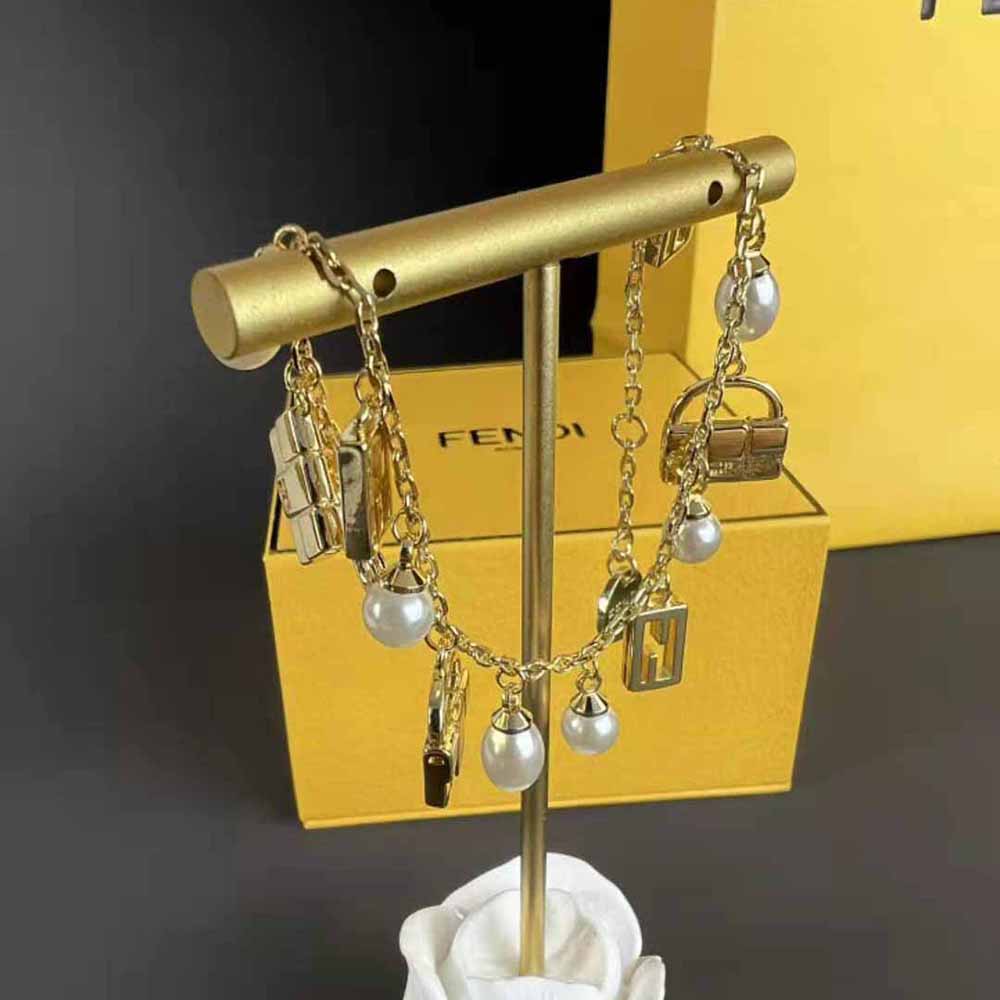 Side angle of Fendi Women Baguette Bracelet Gold-colored showing sleek silhouette