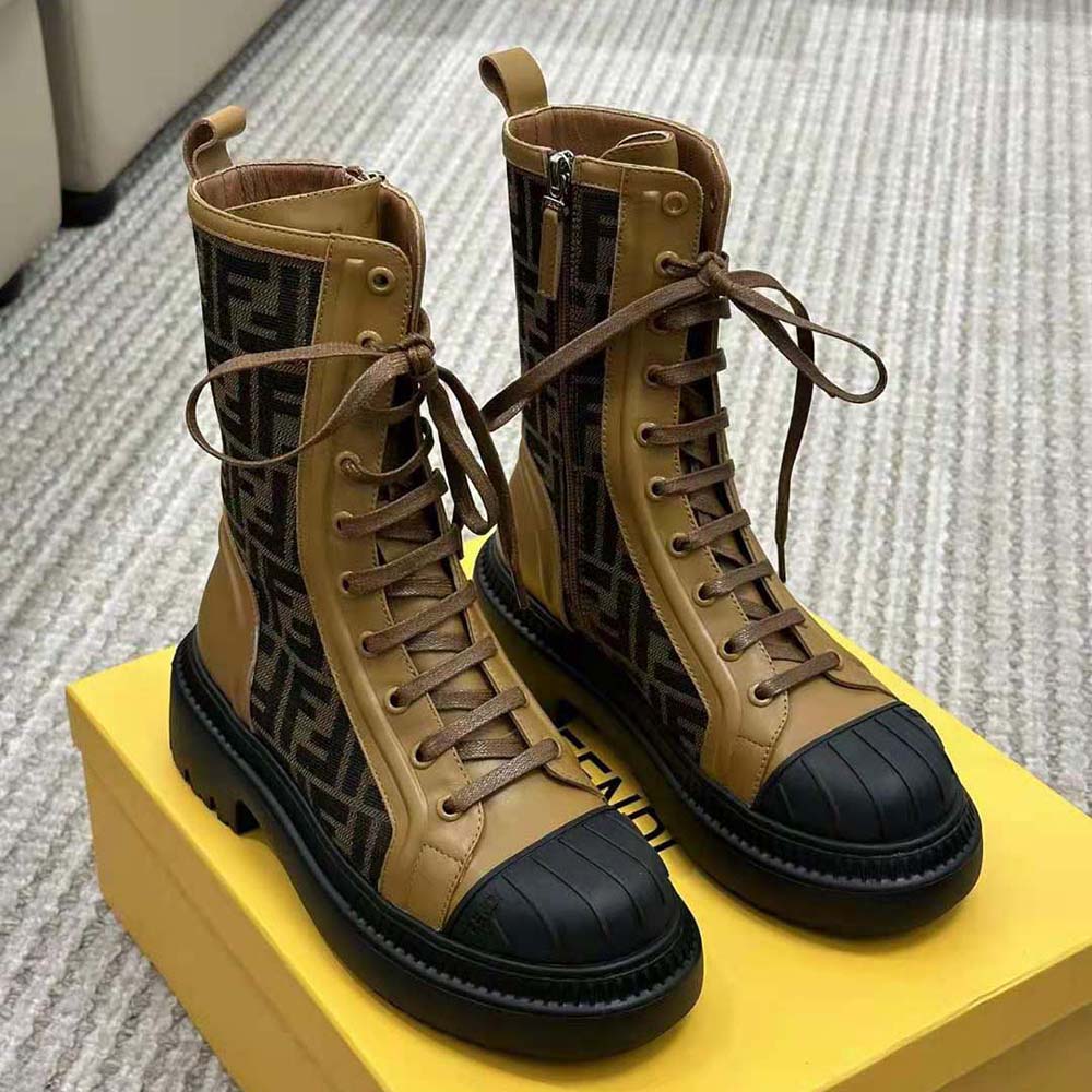 Close-up on Fendi logo hardware on beige leather biker boots