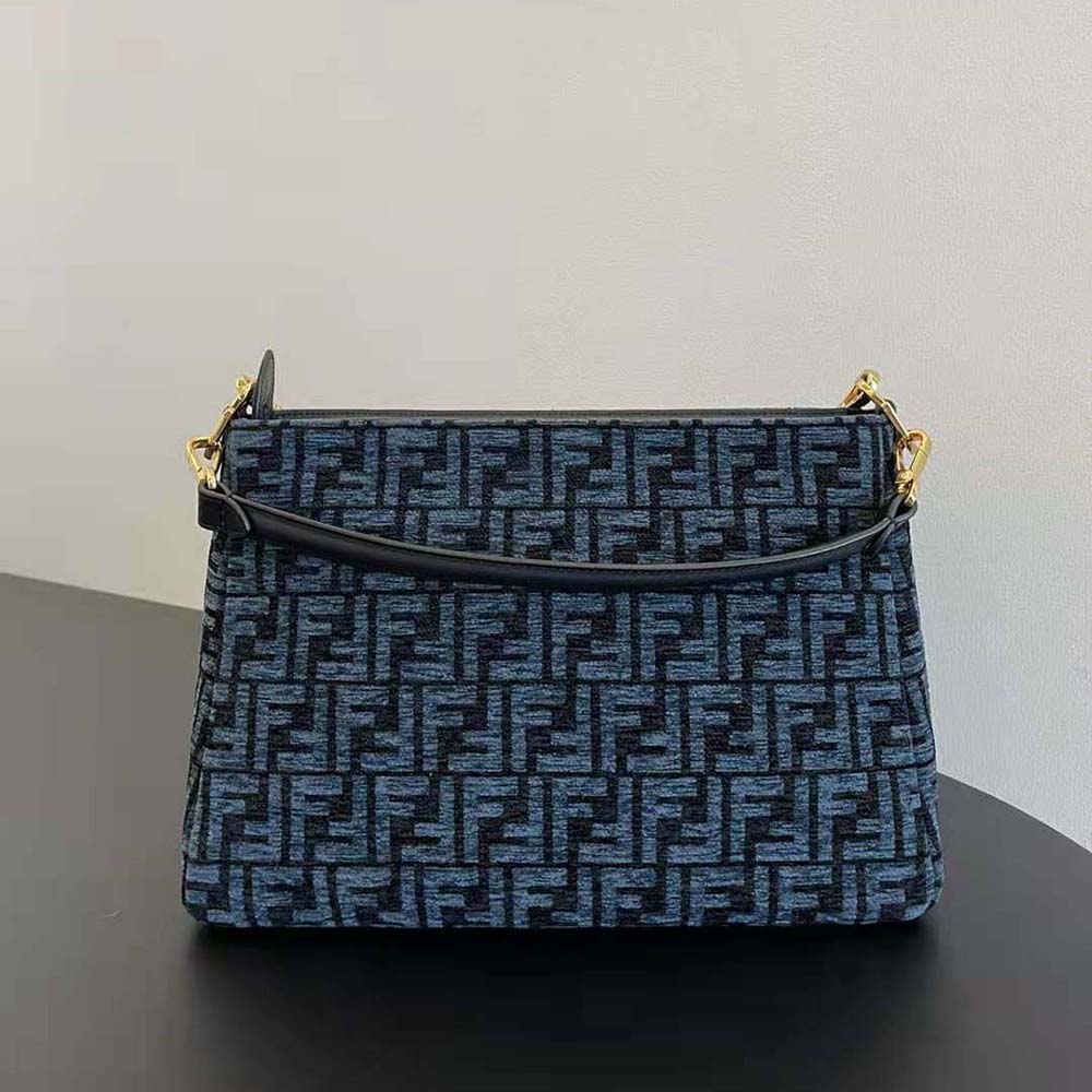 Side angle showing the dark blue tapestry fabric on Fendi shoulder bag