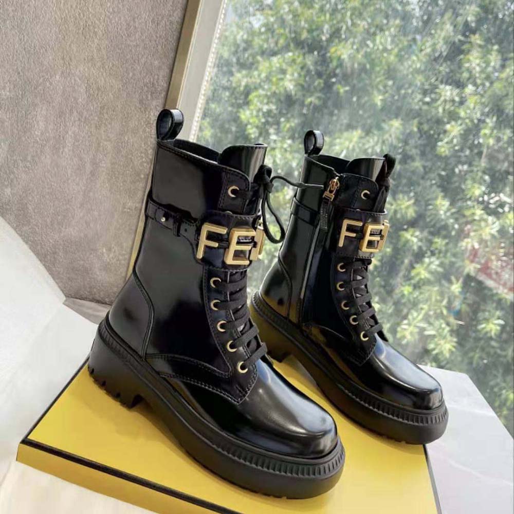 Close-up of Fendigraphy embossed detail on black leather boots