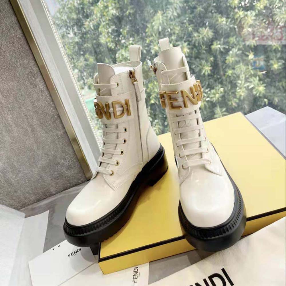 Close-up of embossed Fendigraphy logo on white leather boots