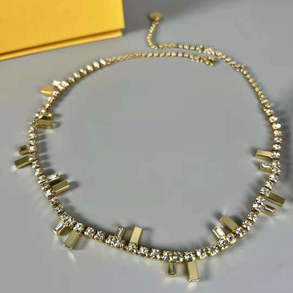 Side angle showing Fendi logo hardware on women’s gold choker