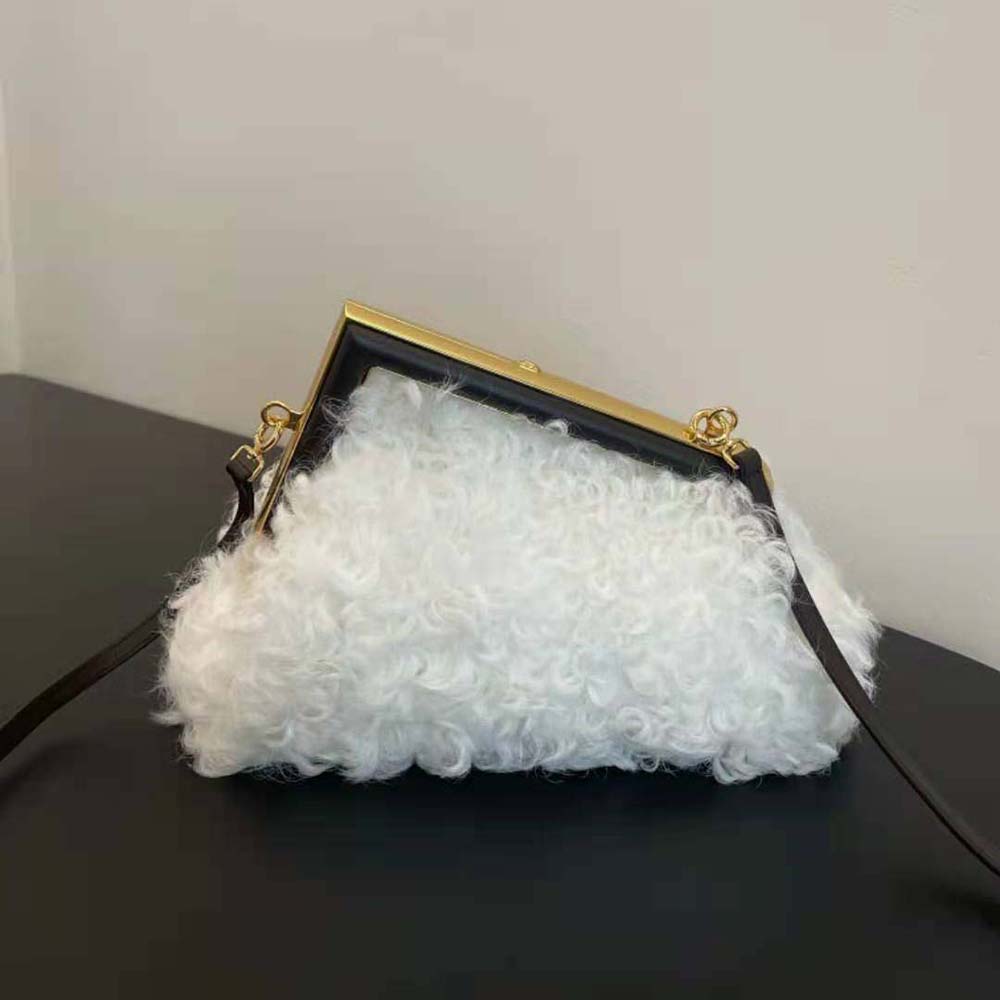 Side angle showing compact silhouette of Fendi Women First Small White Bag