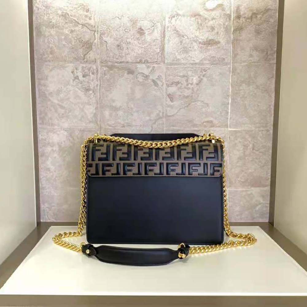 Close-up on gold hardware detail of Fendi Women Kan I Black Leather Bag-Black