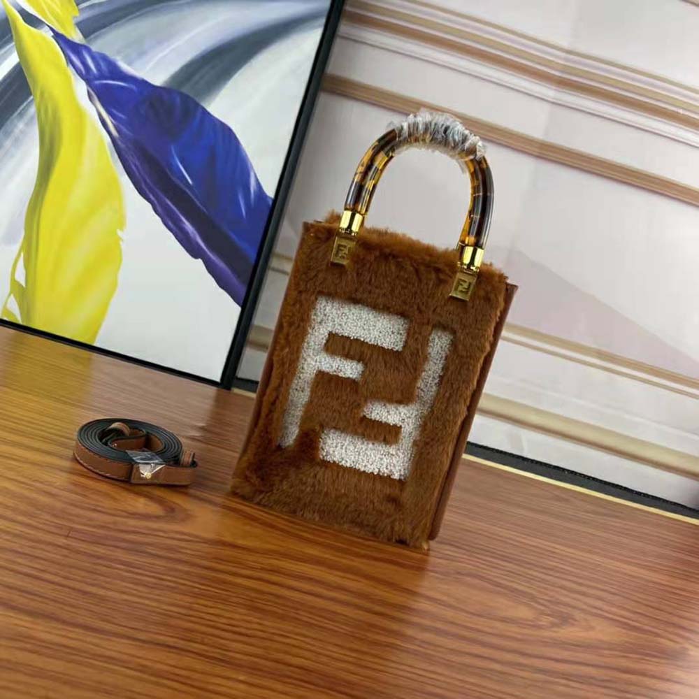 Close-up of gold-tone hardware and signature inlay on Fendi mini-bag