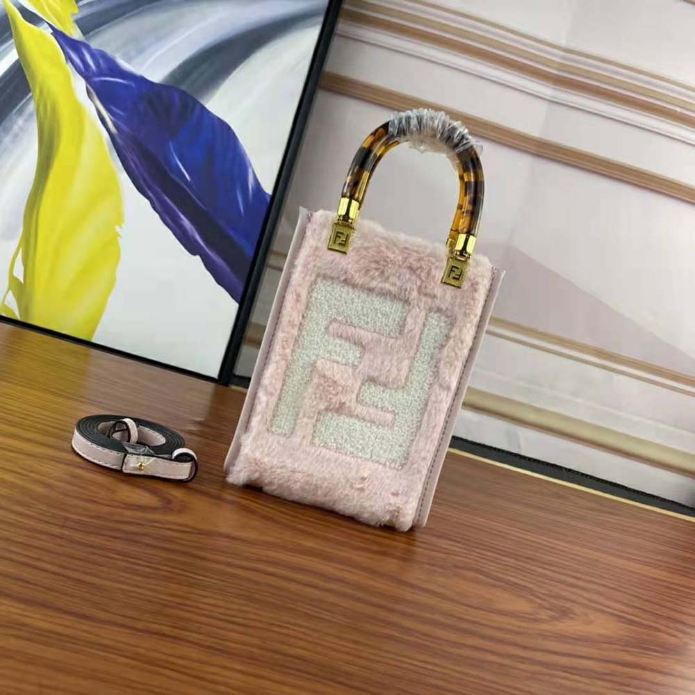 Close-up of pink sheepskin and gold-tone inlay detail on Fendi mini-bag