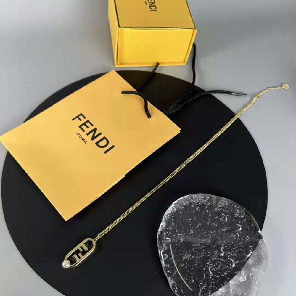 Close-up detail of signature O’Lock pendant on Fendi necklace