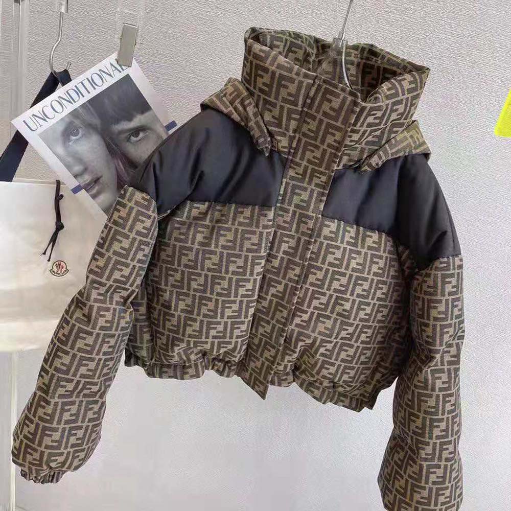 Close-up of signature Fendi hardware on brown canvas ski jacket