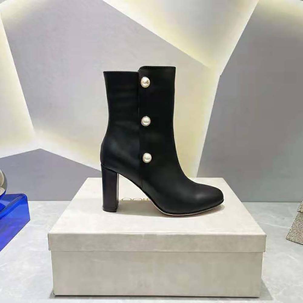 Close-up detail of pearl embellishments on Jimmy Choo black leather boots