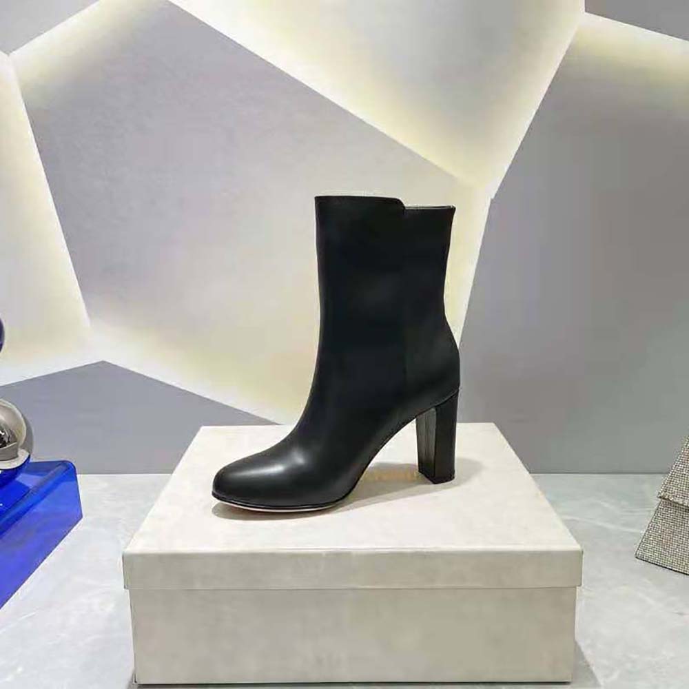 Side view showing high heel and zipper on Jimmy Choo mid-calf boots