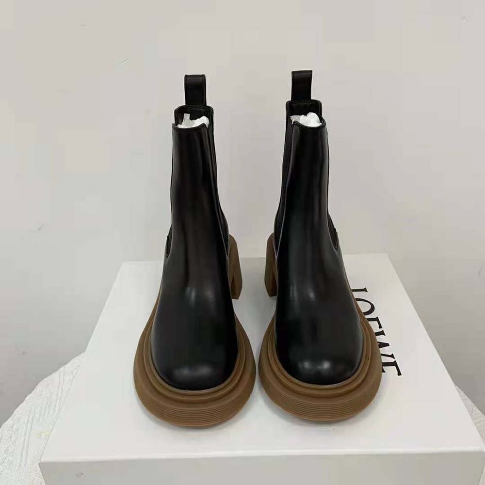 Close-up on smooth black calfskin and embossed Loewe logo on boot