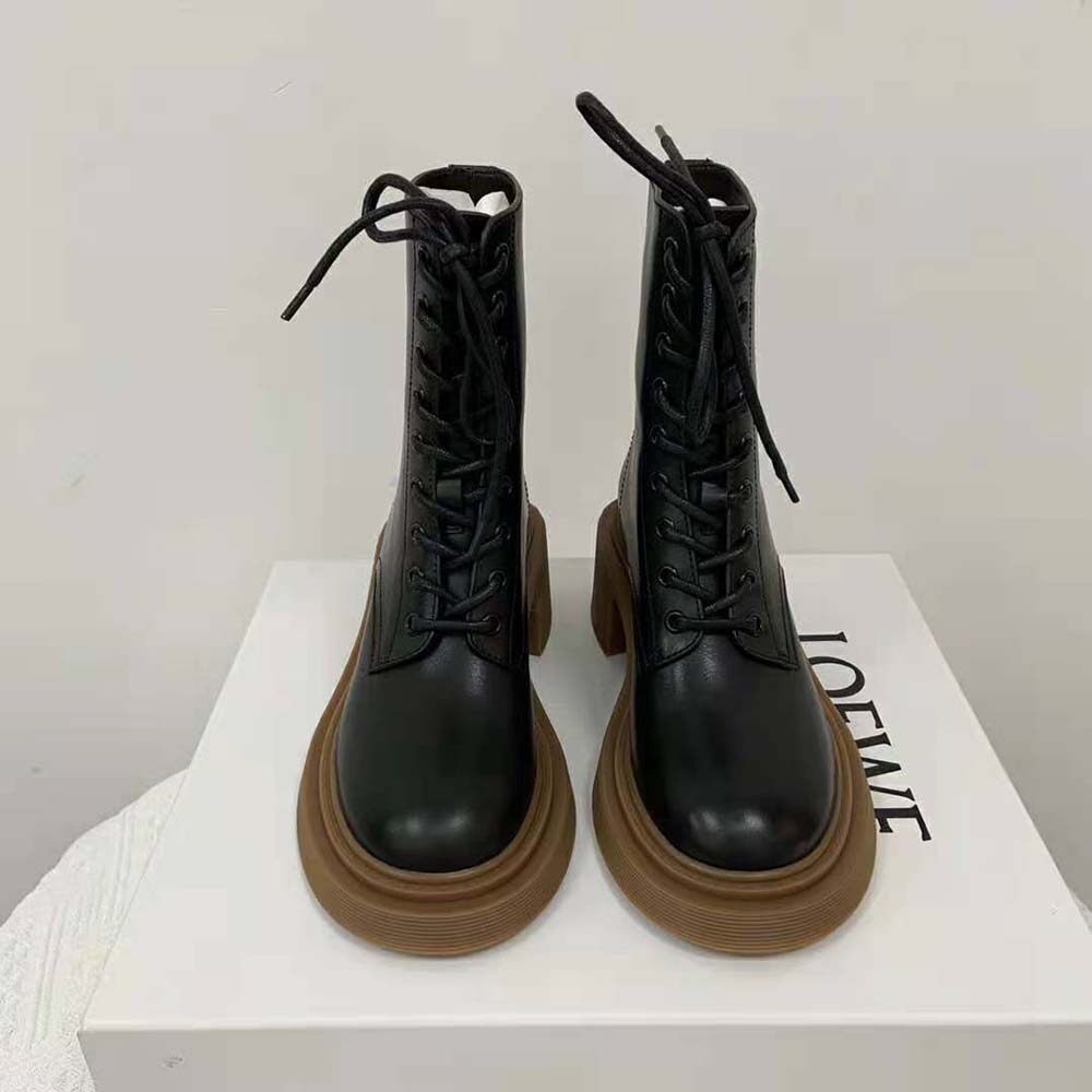 Close-up of black calfskin leather and metal eyelets on Loewe combat boot