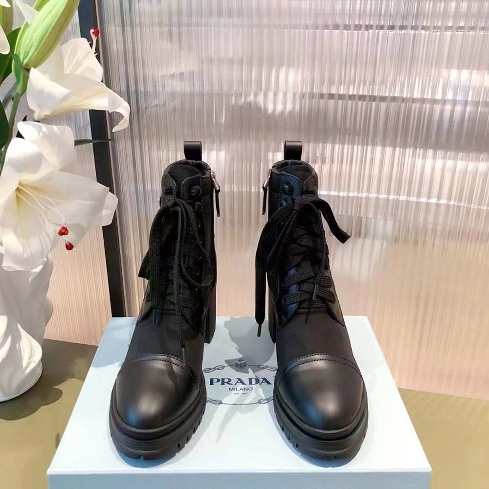 Close-up of brushed leather and Prada logo on booties