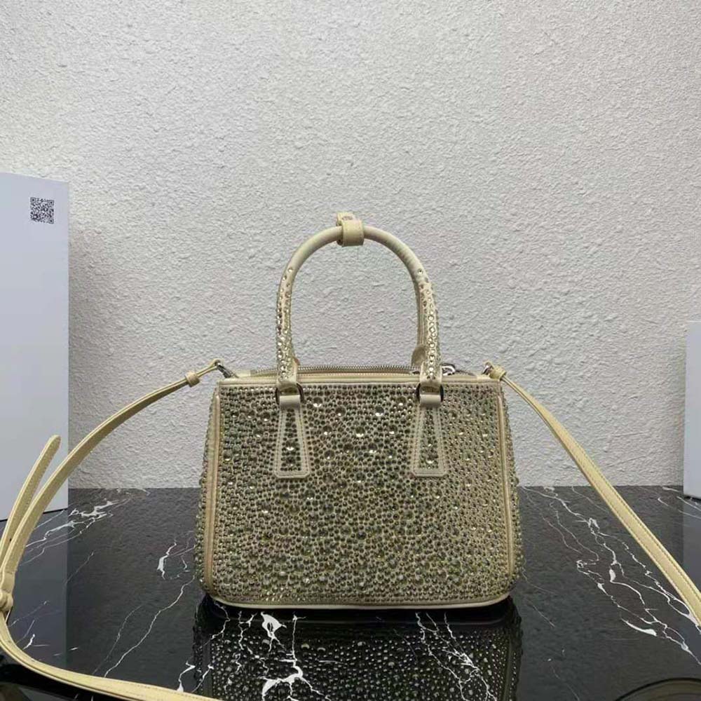 Side angle showing satin texture and gold hardware on Prada mini-bag