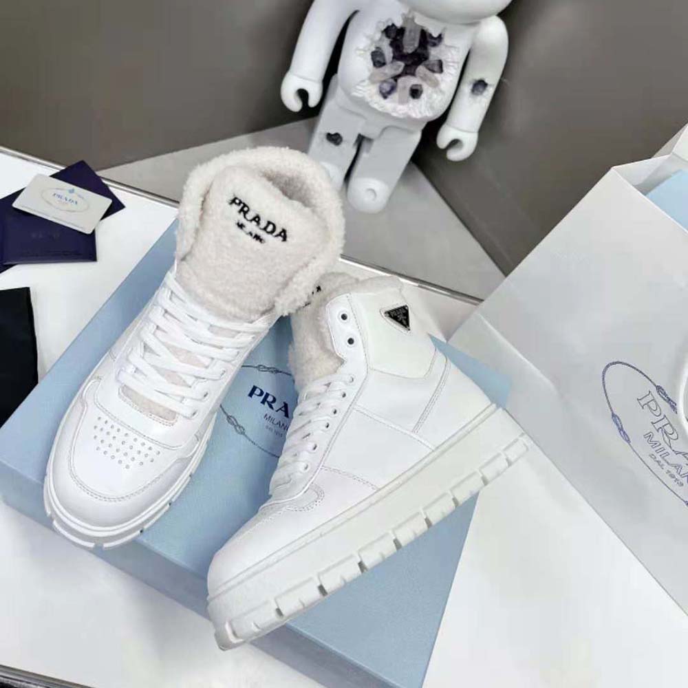 Front angle showing lace-up and branding on Prada Women High-Top Sneakers