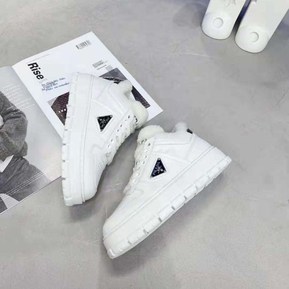 Top-down angle showing lace-up details on Prada white sneakers
