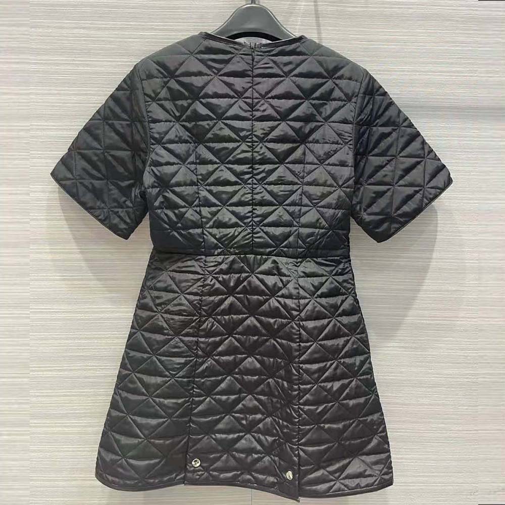 Close-up of Prada logo hardware on black Re-Nylon dress sleeve