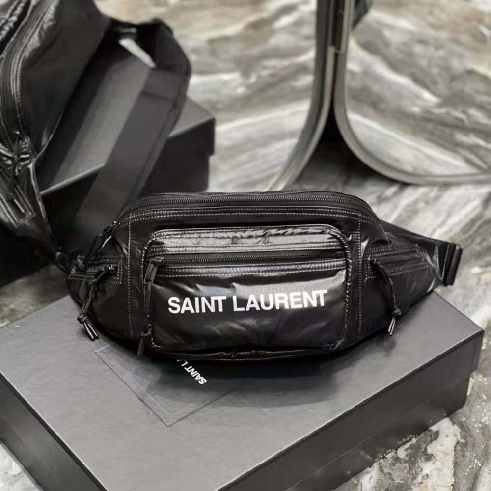 Close-up of silver YSL logo hardware on black Saint Laurent crossbody bag