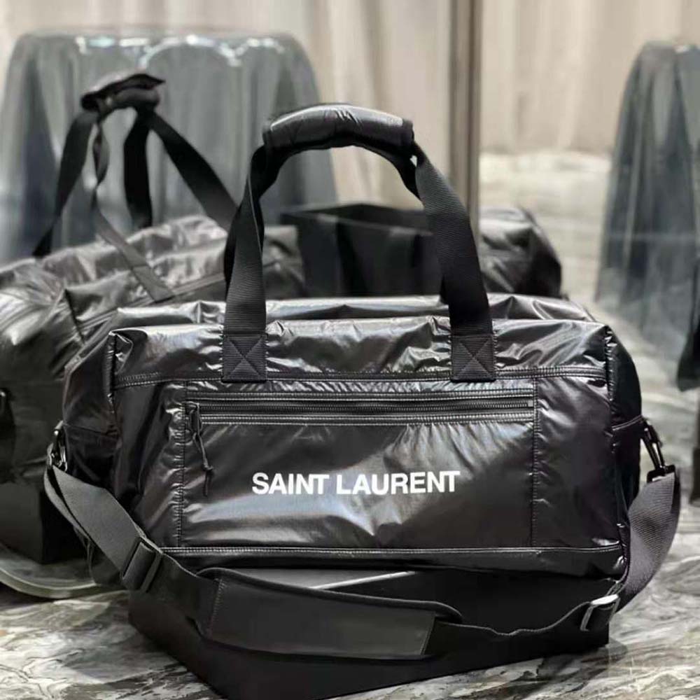 Close-up detail of silver YSL hardware on black nylon duffle