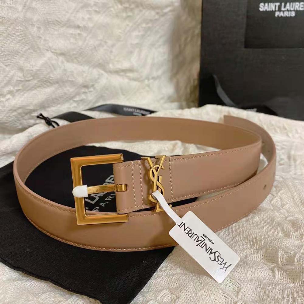 Close-up of sandy lacquered leather and YSL engraved buckle detail
