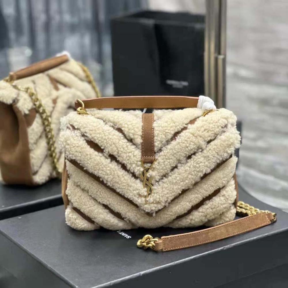 Close-up of gold YSL logo and chain on Saint Laurent bag