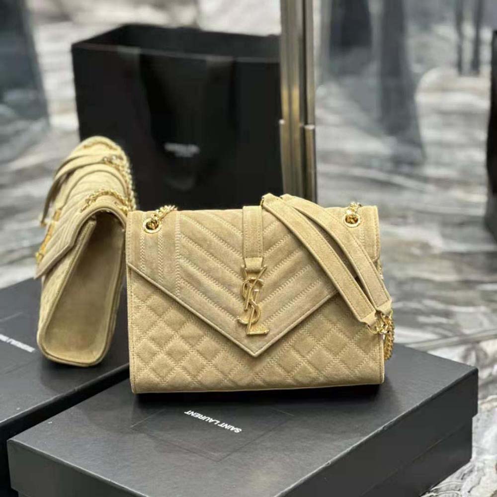 Close-up of gold YSL logo and chain on Envelope Medium Chain Bag