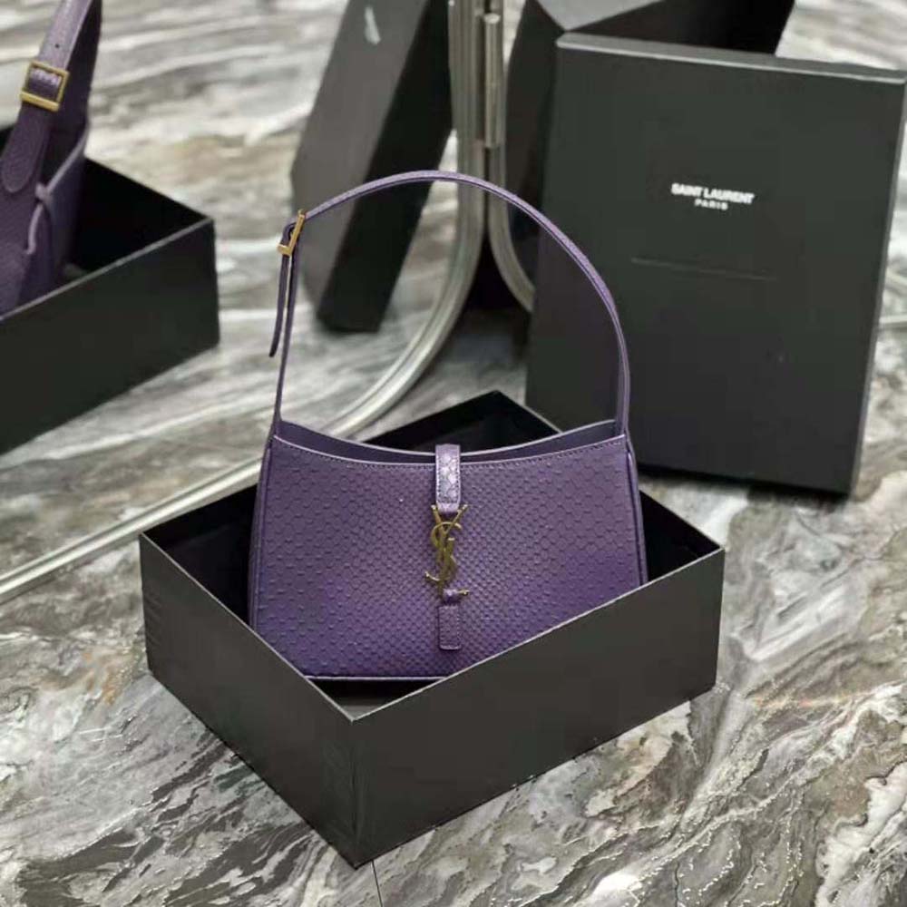Close-up of gold YSL logo hardware on python purple bag