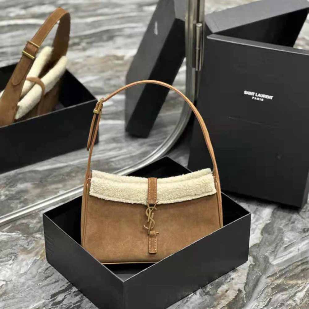 Close-up of shearling trim and YSL gold hardware on hobo bag