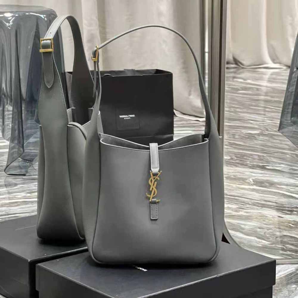 Close-up on gold YSL hardware detail on gray small hobo bag