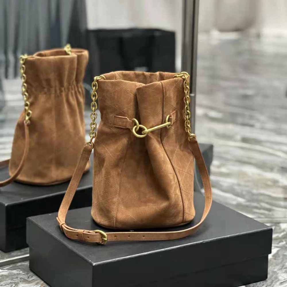 Close-up on gold chain-link hardware of Saint Laurent YSL bucket bag