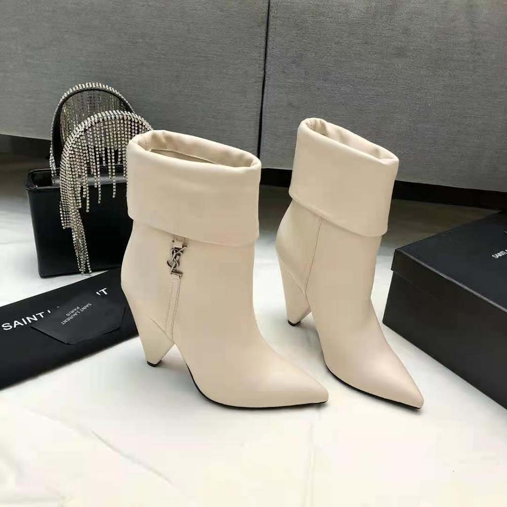 Top angle showing ankle silhouette and zipper on white Niki Booties
