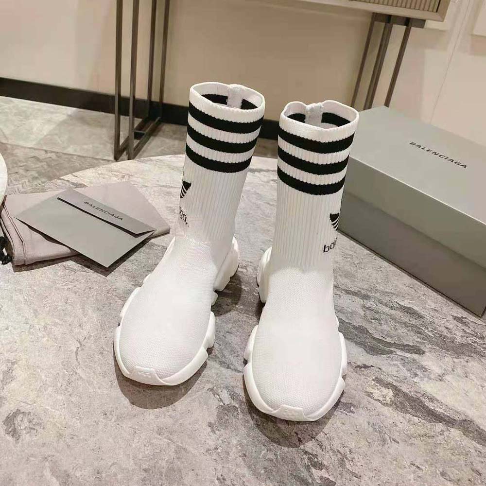Close-up of smooth white leather and Adidas collaboration logo on Balenciaga sneaker