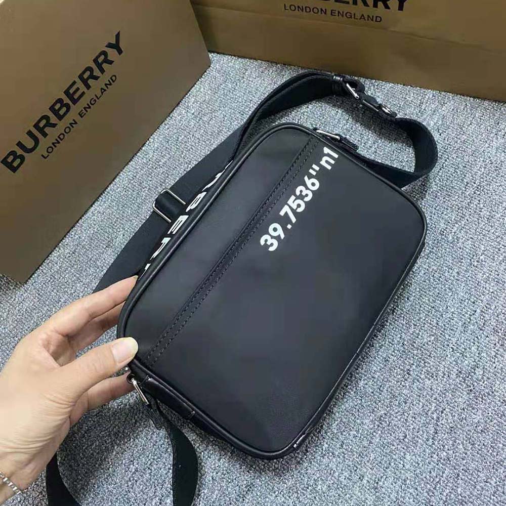 Side angle highlighting adjustable strap of Burberry Men Coordinates Print Nylon Crossbody Bag-Black