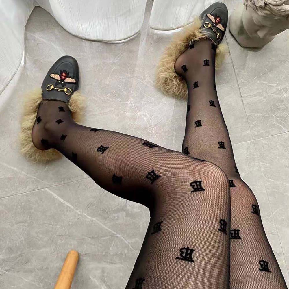 Side angle of Burberry Women Crystal Letter Graphic Tights highlighting fit and texture