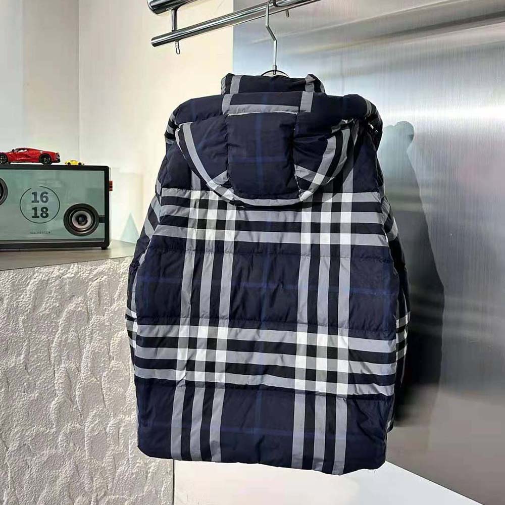 Side angle showing detachable hood and zip closure on Burberry blue puffer jacket