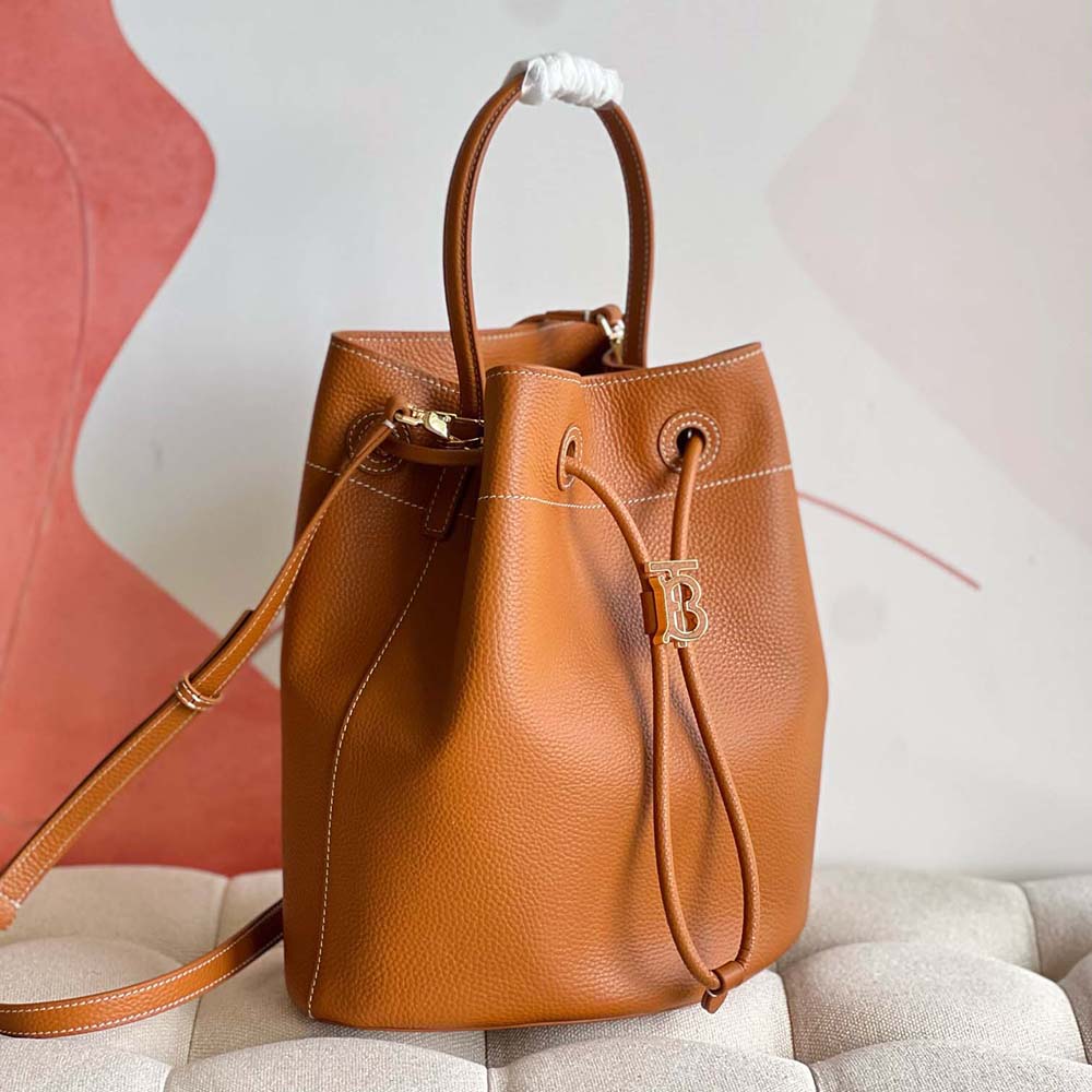 Side angle showing grainy leather texture on Burberry Small TB Bucket Bag