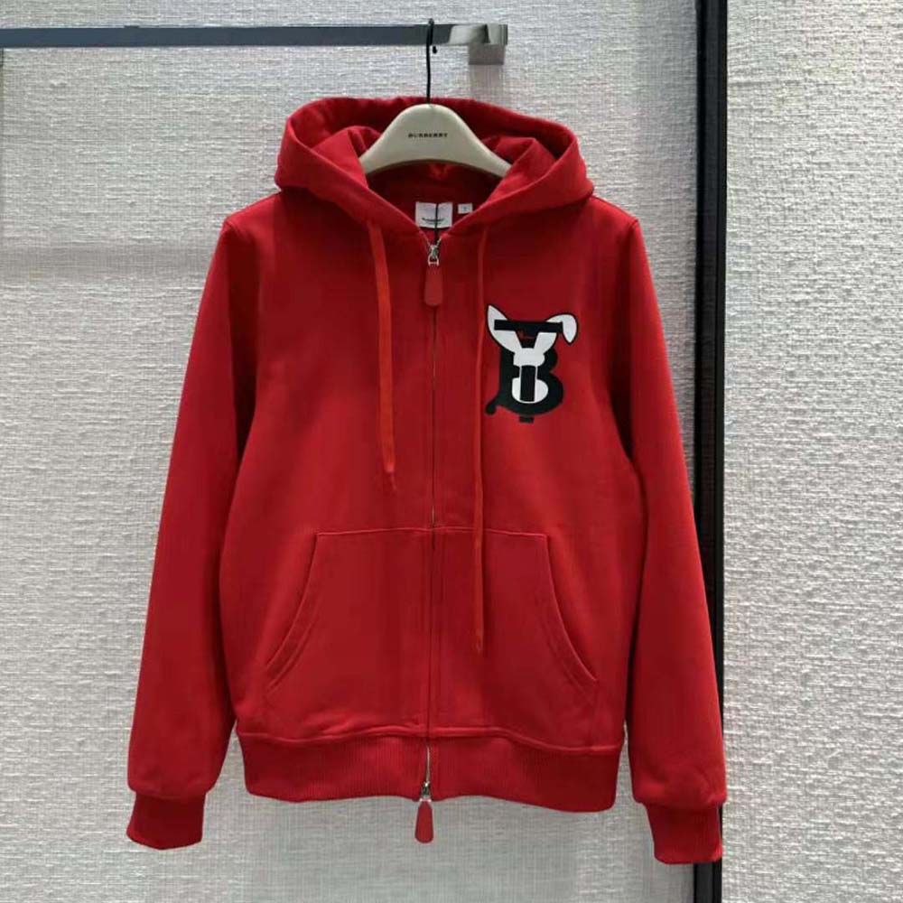Close-up detail of red cotton fabric and rabbit print on Burberry hooded top