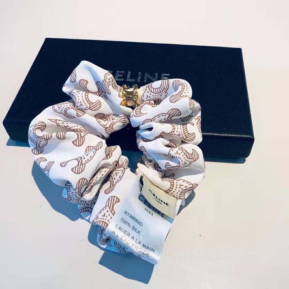 Side view of the bracelet showing white silk and gold-finish brass