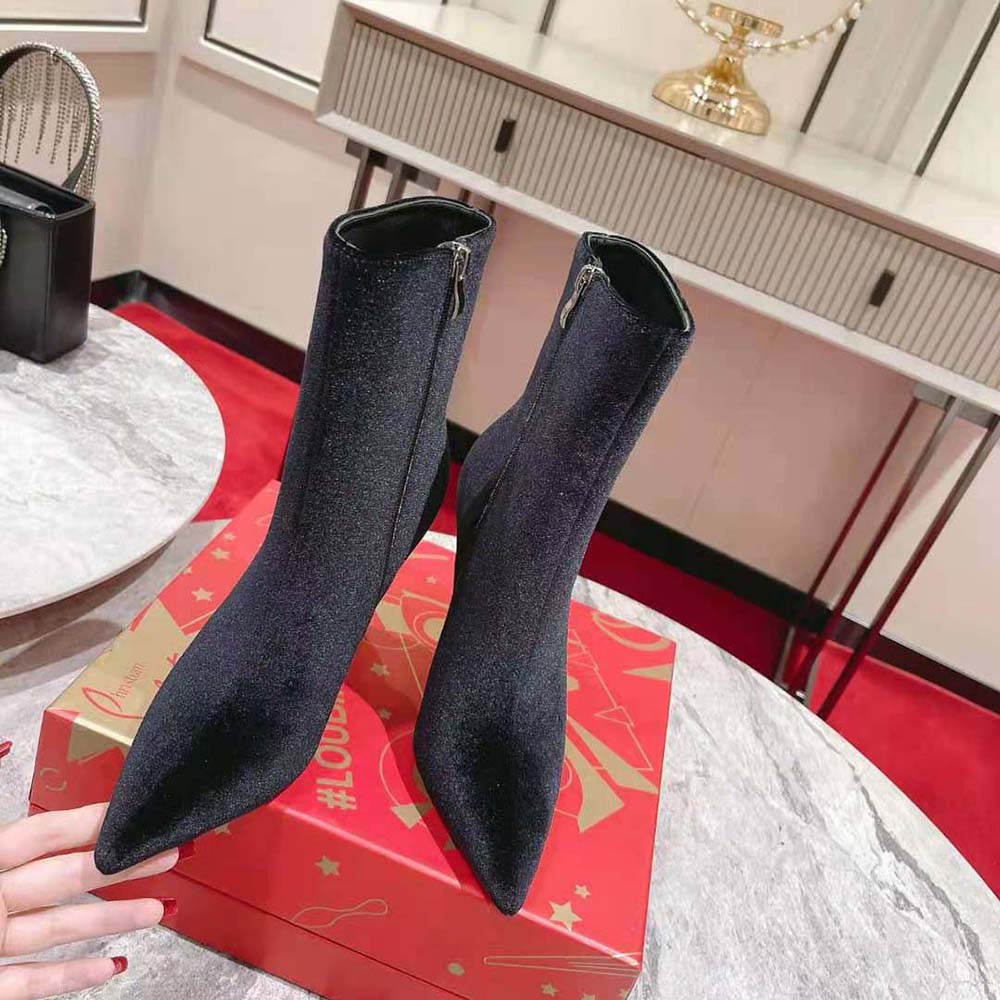 Close-up on signature red sole of Christian Louboutin Women Lipbooty boots