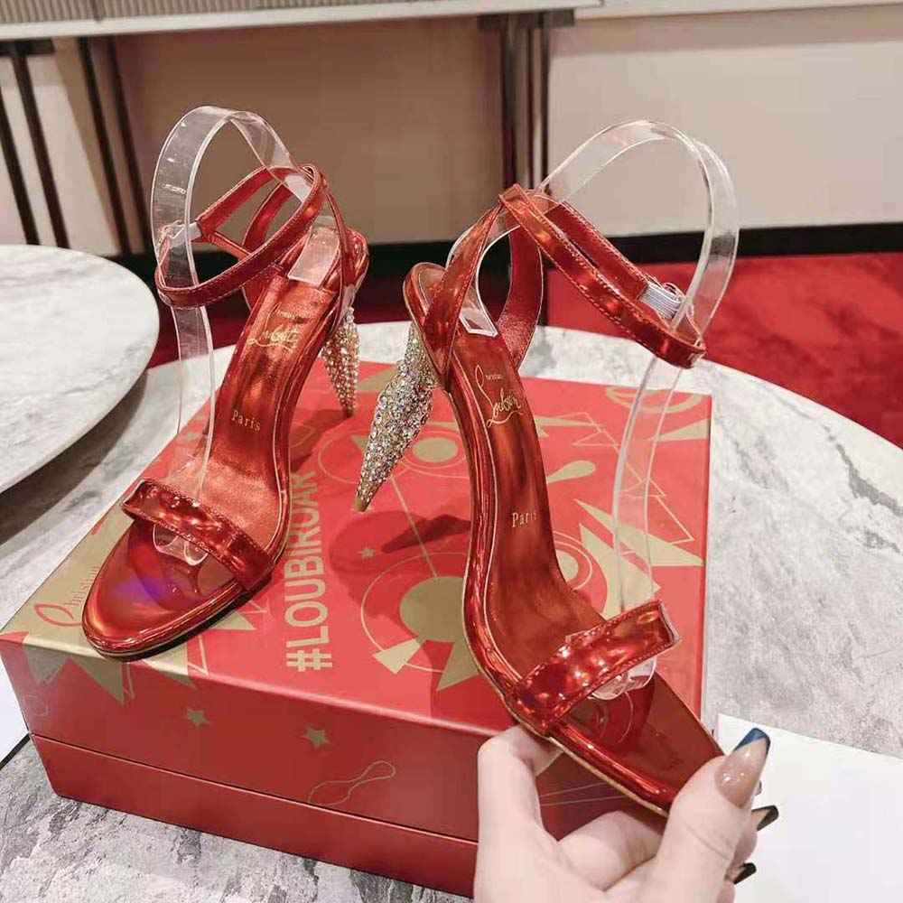 Back angle showing signature red sole and ankle strap of Lipstrass Queen heels