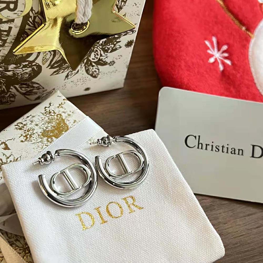 Lifestyle image of Dior Women 30 Montaigne Earrings worn with silver outfit