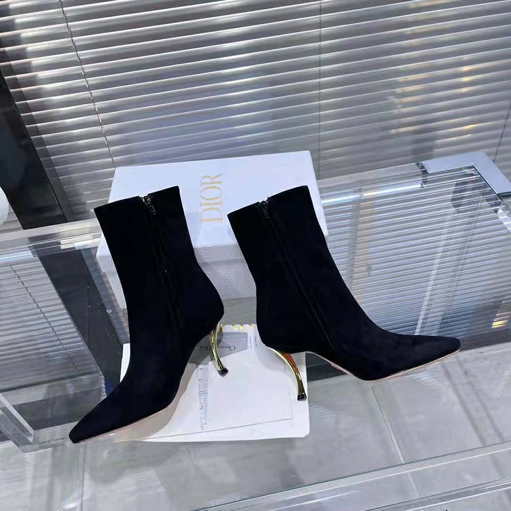 Close-up of black suede texture and Dior heel hardware