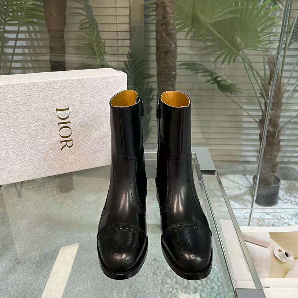 Close-up on perforated black calfskin and gunmetal Dior 'D' logo detail
